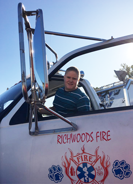 male student in a fire truck