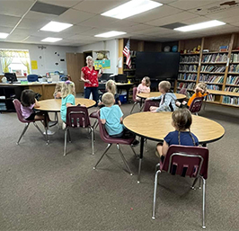 Melissa S. in the library with students