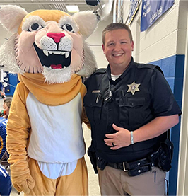 Mascot next to SRO Nate Warren