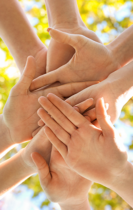 Hands stacked together outside