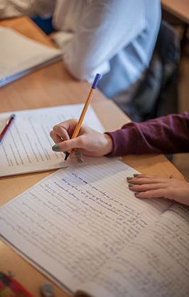 Student writes in a notebook