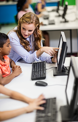 Teacher helps student with computer work